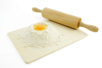 Fototapeta na wymiar dough with rolling pin and flour