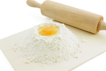 flour and eggs on wooden board