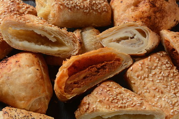 Vegetarian samosas pastries filled with potato, mushrooms, tuna. Middle Eastern food- samsa Bourekas delicious Middle Eastern hand pies. Baked, stuffed pastries filled with potato, mushrooms, tuna.