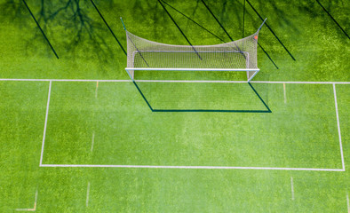 Football net on the background of a green football field. Aerial view of football gate