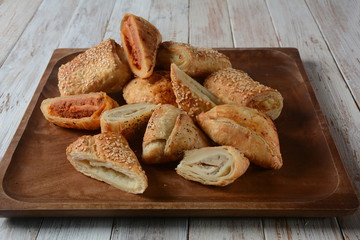 Vegetarian samosas pastries filled with potato, mushrooms, tuna. Middle Eastern food- samsa Bourekas delicious Middle Eastern hand pies. Baked, stuffed pastries filled with potato, mushrooms, tuna.