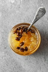 candied fruit jelly. pear marmalade with coffee beans. Jar of pear jam