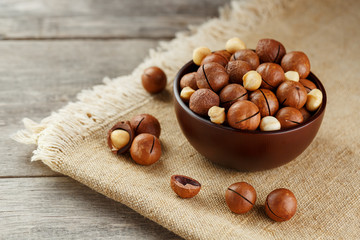 Macadamia nut on wooden background with vintage cloth, concept of superfoods and healthy food