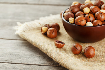 Macadamia nut on wooden background with vintage cloth, concept of superfoods and healthy food