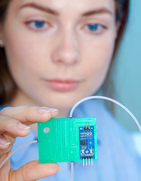 Girl Holding Polymers Bio-MEMS Biomedical Microelectromechanical Systems / LOC Lab-on-a-chip Device (concept Design)