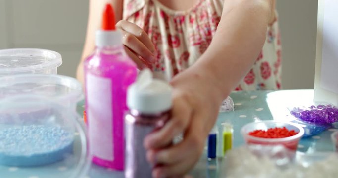 Close Up Dolly Shot Of Girl Making And Playing With Slime