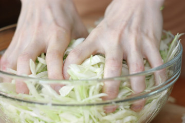 woman preparing salad in kitchen