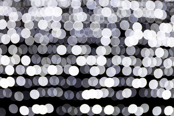 Abstract bokeh of white city lights on black background. defocused and blurred many round light