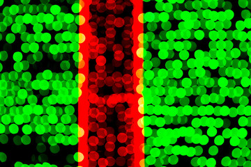 Unfocused abstract green and red bokeh on black background. defocused and blurred many round light