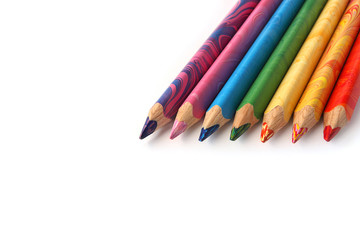 Color pencils on a white background. Spectrum of a rainbow. Back to school. Selective focus, close-up.