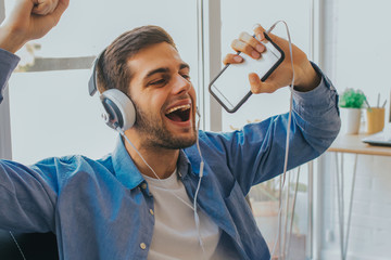 man with mobile phone and singing headphones