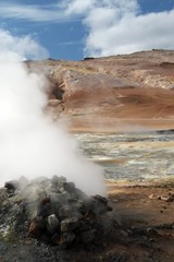 Fototapeta na wymiar Seltun / Krysuvik (Krýsuvík): Steaming fumarole on geothermal field with yellow deposits of sulfates
