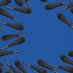 screwdriver with orange and black plastic with rubber handle with bat on blue denim background. Seamless background with space for text