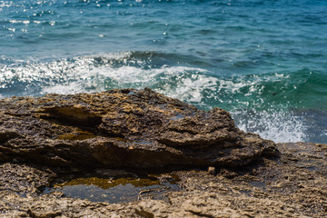 Waves breaking on a stony beach in Murter, Croatia, Dalmatia