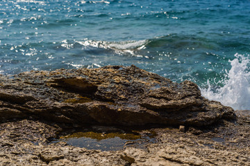 Waves breaking on a stony beach in Murter, Croatia, Dalmatia