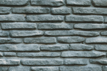 Vintage grey stone wall texture. Decorative pattern of gray rock background. Blank concrete brick wall surface.