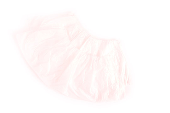 New plastic shoe covers for shoes, disposable white shoe covers on a light background. Selective focus, top view.