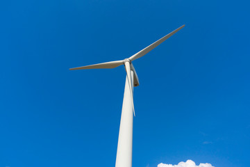 wind turbine against blue sky.