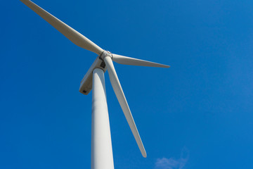 wind turbine against blue sky.