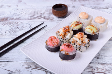 Sushi rolls assortment on a white ceramic plate