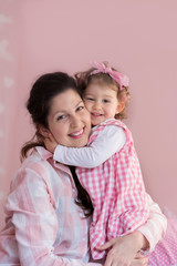 Happy Mother with her Baby Girl Hugging at Home  .Mother and Daughter .Happy Family, Mother with Little Child