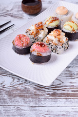 Sushi rolls assortment on a white ceramic plate