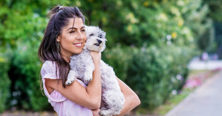 Obraz premium Beautiful Smiling Woman Hugging Her Cute Havanese Dog .Pet and Owner Outdoor