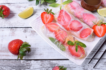 Spring rolls with strawberry, fruits and sauce. Vietnamese cuisine snack