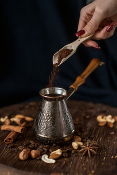 Turk spices nuts hand with a spoon pours coffee 