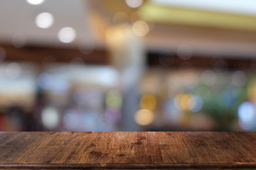 Empty dark wooden table in front of abstract blurred bokeh background of restaurant . can be used for display or montage your products.Mock up for space.