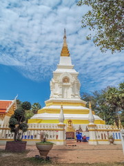 Fototapeta premium view of white chedi name is Phra That Bang Phuan with buddhist people worship and cloudy sky background, Wat Phra That Bang Phuan, Nong Khai, Thailand.