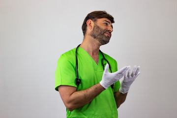Portrait of male veterinary doctor in green uniform with brown hair in love, facing forwards and...