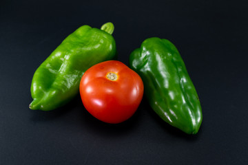fresh red tomato and pepper on a gray background