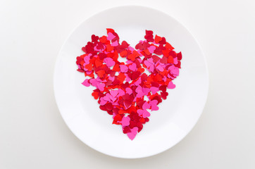 Top view red heart shape on a white plate. Romantic dinner
