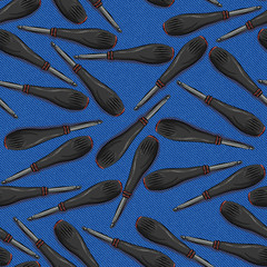 screwdriver with orange and black plastic with rubber handle and bit on blue denim background. Seamless background