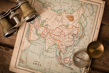 Binoculars and Compass on 1870 Map of Asia – World Travel