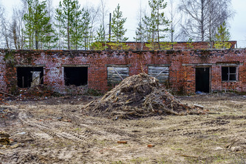 remains of a farm building of concrete slabs and red bricks