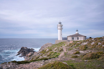Fototapeta na wymiar Tourinan Lighthouse in Muxia, Galician coast. Northern Spain