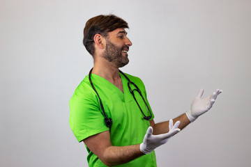 Portrait of male veterinary doctor in green uniform with brown hair looking prideful, facing...