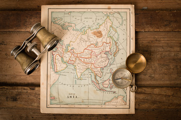 Binoculars and Compass on 1870 Map of Asia – World Travel