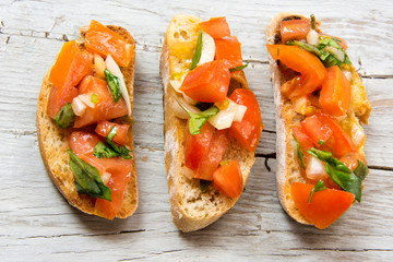 Bruscheta, antipasti Typical Italian with tomato, basil and toast