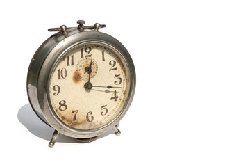 Old alarm clock isolated on white background