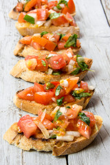 Bruscheta, antipasti Typical Italian with tomato, basil and toast