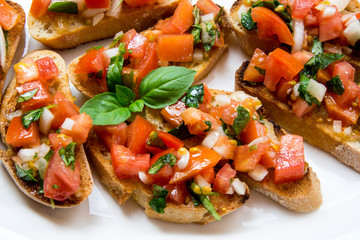 Bruscheta, antipasti Typical Italian with tomato, basil and toast