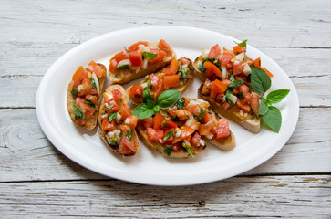 Bruscheta, antipasti Typical Italian with tomato, basil and toast
