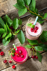 Cherry and raspberry fruit Yogurt smoothie or milk shake in glass jar on a wooden table rustic. Natural detox, fruit dessert, healthy dieting concept.