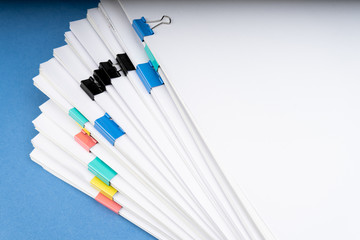 Mock up, stack of papers documents in archives files with paper clips on desk at offices, business concept. Copy space.