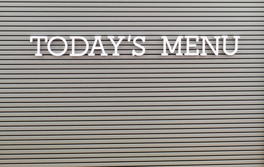 Today's menu written with white plastic letters on grey board with copy space