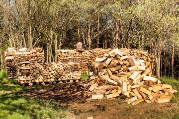 Firewood on a pile. Preparing for the winter. Green house heating. Farm life. Wood cutting.