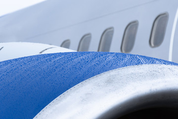 View of the engine of the aircraft, raindrops on a wet surface.